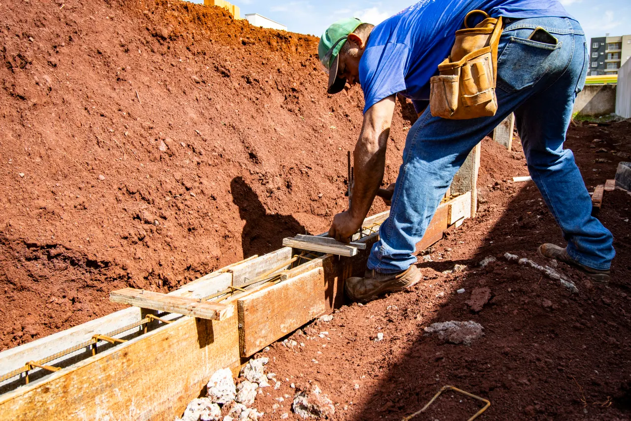 Footing formwork set in a trench for a new retaining wall