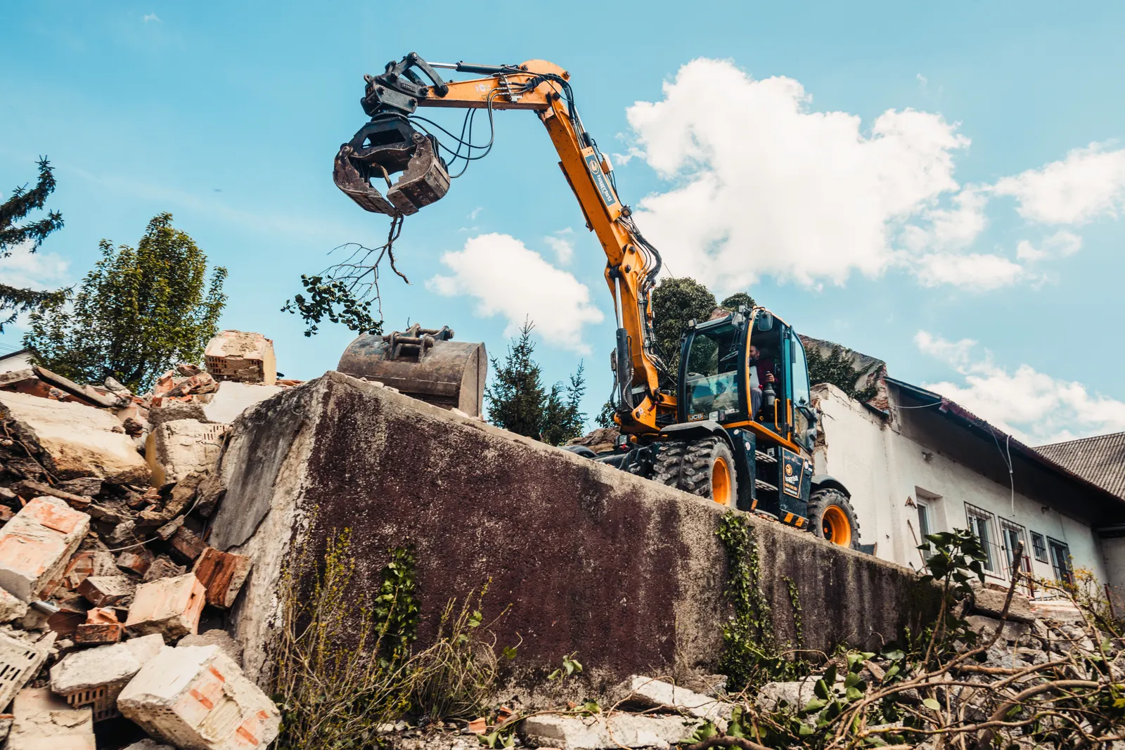 Old retaining wall being removed before a replacement wall is built